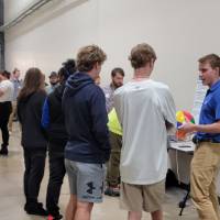 people talking to a senior project designer